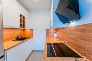 a kitchen with a sink and wooden counter top at Flex SelfCheckIns 142 - Zagreb - Bedroom - Garage - Loggia in Zagreb