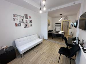 a living room with a white couch and a bedroom at Annarè House in Ischia