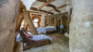 a bedroom with a bed in a stone building at Portal Xibalba in Playa del Carmen +145 photos
