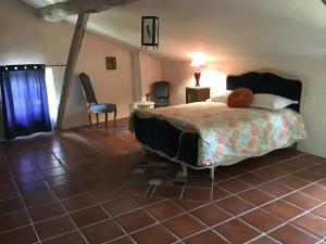 a bedroom with a bed with a teddy bear on it at Le Mas de l’Amandier in Ribaute-les-Tavernes