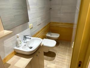 a bathroom with a sink and a toilet at Annarè House in Ischia +7 photos