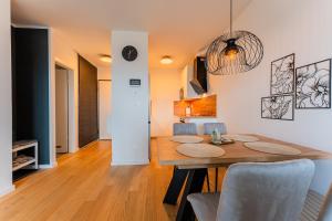a dining room and living room with a table and chairs at Flex SelfCheckIns 142 - Zagreb - Bedroom - Garage - Loggia in Zagreb