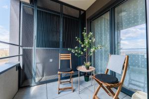 two chairs and a table on a balcony at Flex SelfCheckIns 142 - Zagreb - Bedroom - Garage - Loggia in Zagreb +40 photos