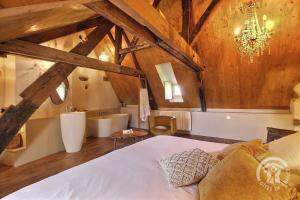 a bedroom with a bed and a sink and a tub at Hotel des ducs de bretagne in Saint-Brieuc
