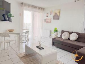 a living room with a couch and a table at Grabels, Piscine et Détente in Grabels