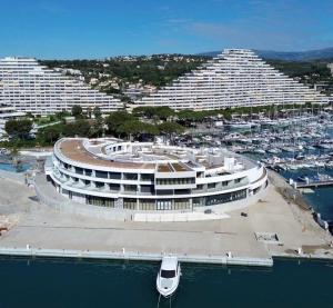 an aerial view of a large building in a harbor at Parc Baie des Anges in Villeneuve-Loubet
