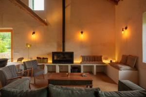 a living room with a couch and a tv at Borda Viñuels in Planillo