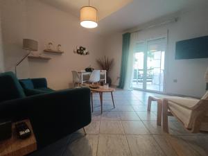 a living room with a couch and a table at Salamina Azuro in Selínia