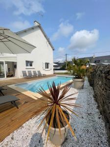 a villa with a swimming pool and a house at La Villa Sénéchal in Guérande
