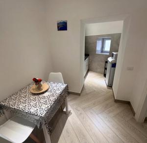 a room with a table and a room with a kitchen at Suite Eleven in Naples