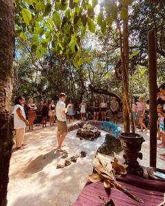a group of people standing around a tree at Portal Xibalba in Playa del Carmen
