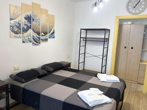a bedroom with a bed and a clock on the wall at Annarè House in Ischia