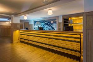 a lobby with a counter with wooden drawers at NH Collection Madrid Suecia in Madrid