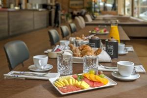a long table with plates of food on it at NH Collection Madrid Suecia in Madrid