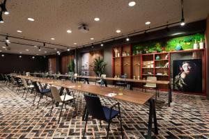 a long long table in a room with chairs at NH Collection Madrid Suecia in Madrid
