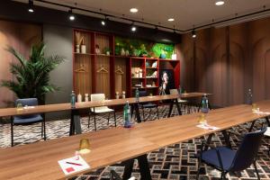 a conference room with wooden tables and chairs at NH Collection Madrid Suecia in Madrid