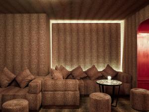 a living room with a couch and a table at NH Collection Madrid Suecia in Madrid