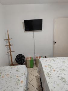 Ένα ή περισσότερα κρεβάτια σε δωμάτιο στο Apartamento pé na areia Praia do Morro