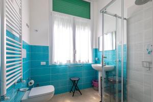 a bathroom with a toilet and a sink and a shower at Congregazione Suore Figlie di San Francesco di Sales in La Spezia