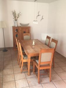 a wooden dining room table with chairs and a table at Zinnowitz, Kneippstr 24 b in Zinnowitz