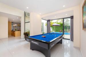 a pool table in a room with a swimming pool at ARIA Resort Vung Tau S01 in Vung Tau
