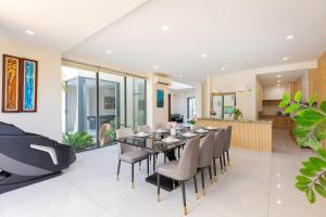 a dining room with a table and chairs at ARIA Resort Vung Tau S01 in Vung Tau