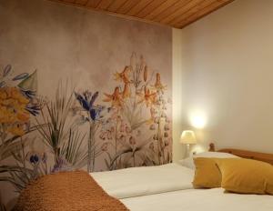 a bedroom with a mural of flowers on the wall at Appartements im Park in Krumpendorf am Wörthersee