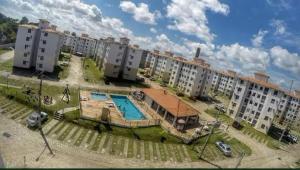 an apartment complex with a swimming pool and buildings at Apto Cop30 - Ideal BR - Completo in Ananindeua