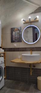 a bathroom with a sink and a mirror at Palmera Pool Villa in Hanioti