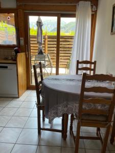 a kitchen with a table and two chairs and a window at Appartement duplex Passy in Passy