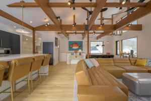 a living room and kitchen with a couch and a bar at Kogane Hills Niseko in Rankoshi