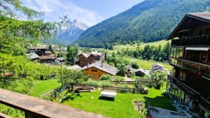 a view of a village with mountains in the background at Chalet Lu Verzache 5 personnes in Evolène
