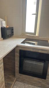 a kitchen with a stove and a microwave at Emma in San Pietro in Bevagna +19 photos