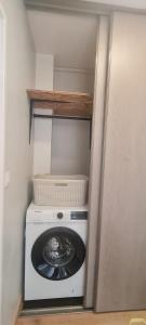 a washing machine with a basket on top of it at Studio proche centre-ville in Autun