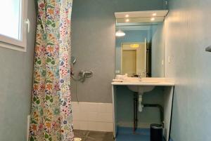 a bathroom with a sink and a shower curtain at Les Naïades F25- 1 bedroom for 4 people in Avène