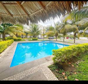 a large blue swimming pool under an umbrella at Casa frank in Valente Díaz y La Loma