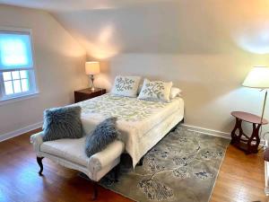a bedroom with a bed and a chair and a window at Family Home in mainheim PA close to atractions in Manheim