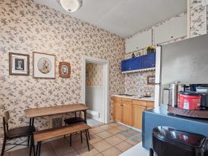 a kitchen with a table and a refrigerator at Governor's Mansion beautiful 3bd with pool table in Leadville