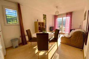 a living room with a table and a couch at Les Naïades I55 - 2 bedroom for 4 people in Avène