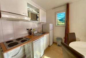 a small kitchen with a stove and a sink at Les Naïades I55 - 2 bedroom for 4 people in Avène +4 photos
