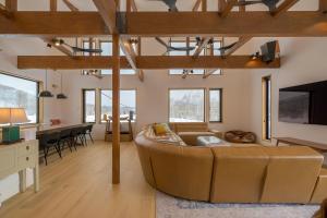 a living room with a large couch and a table at Kogane Hills Niseko in Rankoshi