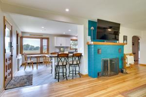 a kitchen and dining room with a blue fireplace at 3 Mi to Lake Onalaska Quaint Home with Prairie View in Onalaska