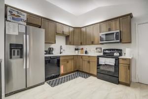 a kitchen with wooden cabinets and stainless steel appliances at Fountain Mountain Trails & Wildlife BBQ Fire Pit in Fountain