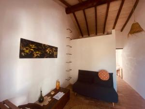 a living room with a couch and a table at Monte das Raizes in São Teotónio