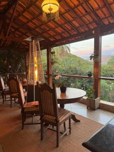 a dining room with a table and chairs and a view at Pousada Belvedere da Serra in Serra do Cipo +130 photos