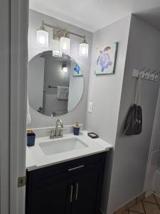 a bathroom with a sink and a mirror at Oceanview 2 Studios adjoining w/pool, kitchenettes in Daytona Beach
