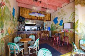 a restaurant with colorful chairs and tables and a bar at Oceanview 2 Studios adjoining w/pool, kitchenettes in Daytona Beach