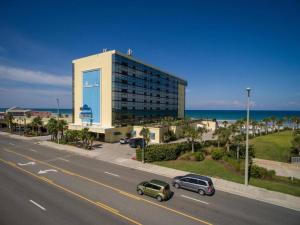 a building on the side of a road next to the ocean at Oceanview 2 Studios adjoining w/pool, kitchenettes in Daytona Beach