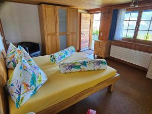 a bedroom with a bed with pillows on it at Försterhaus Dalin Ferienwohnung Schweizer Alpen in Präz