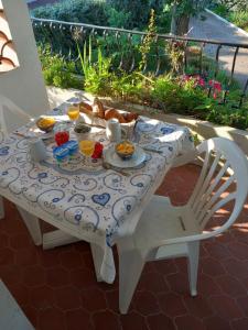 a white table with a plate of food on it at Villa Do Sol Chambre d'Hôtes "La Dune" in Arcachon
